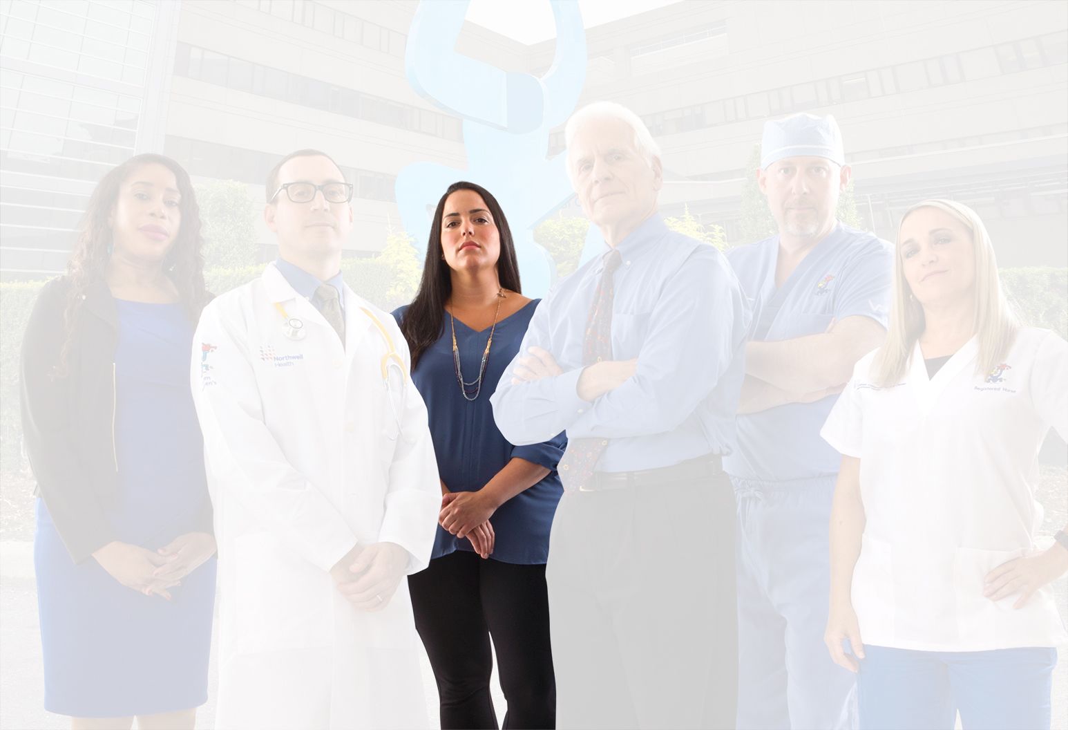 A Child Life Specialist stands heroically in the middle of the group. She separates from the rest of the team and the background.